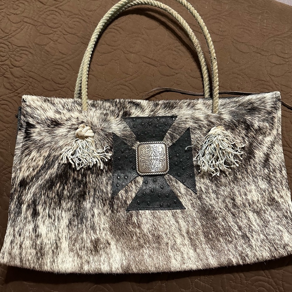 Very cute cowhide purse, 1 pocket. Hardly ever been used, very good condition!